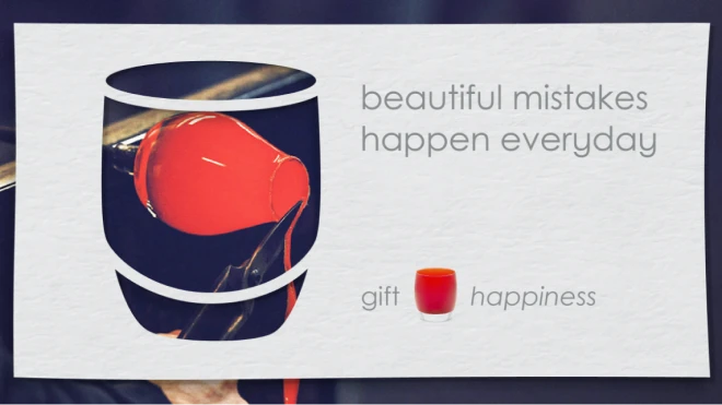 A red glass piece being made in glassblowing process within the shape of a votive, with the text "beautiful mistakes happen everyday".  Below, the words "gift" and "happiness" are shown.