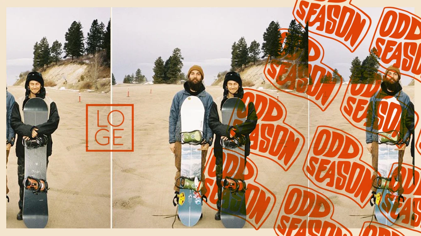 Two snowboarders stand on sand against sparse trees and a cloudy sky, holding their snowboards vertically. The image, labeled "LOGE" and "ODD SEASON," humorously contrasts the expectation of snow.