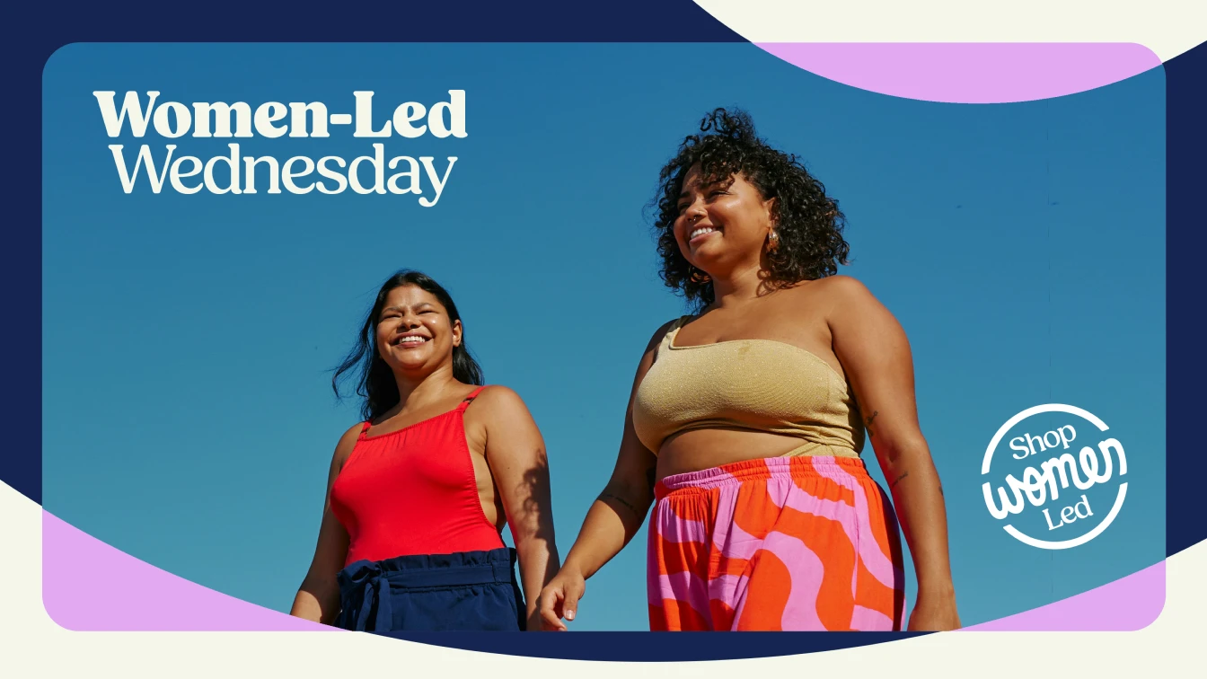 Two women smile and walk together under a clear blue sky. Text reads "Women-Led Wednesday" and "Shop Women Led."